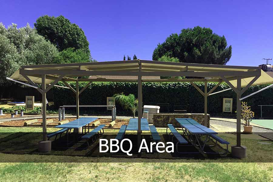 Picnic benches under a large canopy