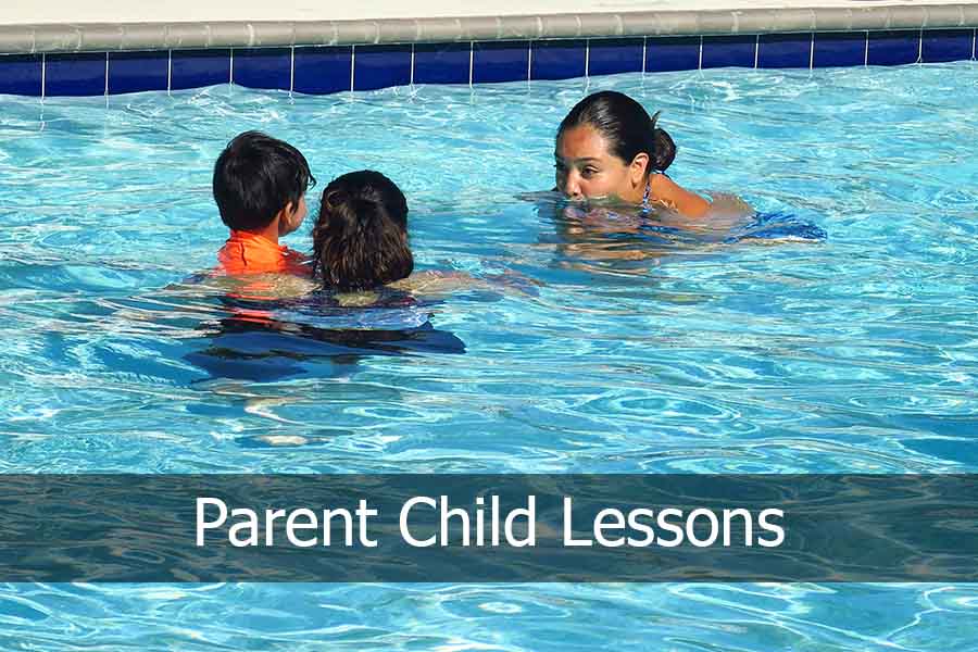 Instructor teaching parent child lesson in the pool
